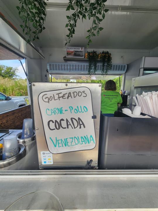 Coco's Juancho truck window with a cocada sign